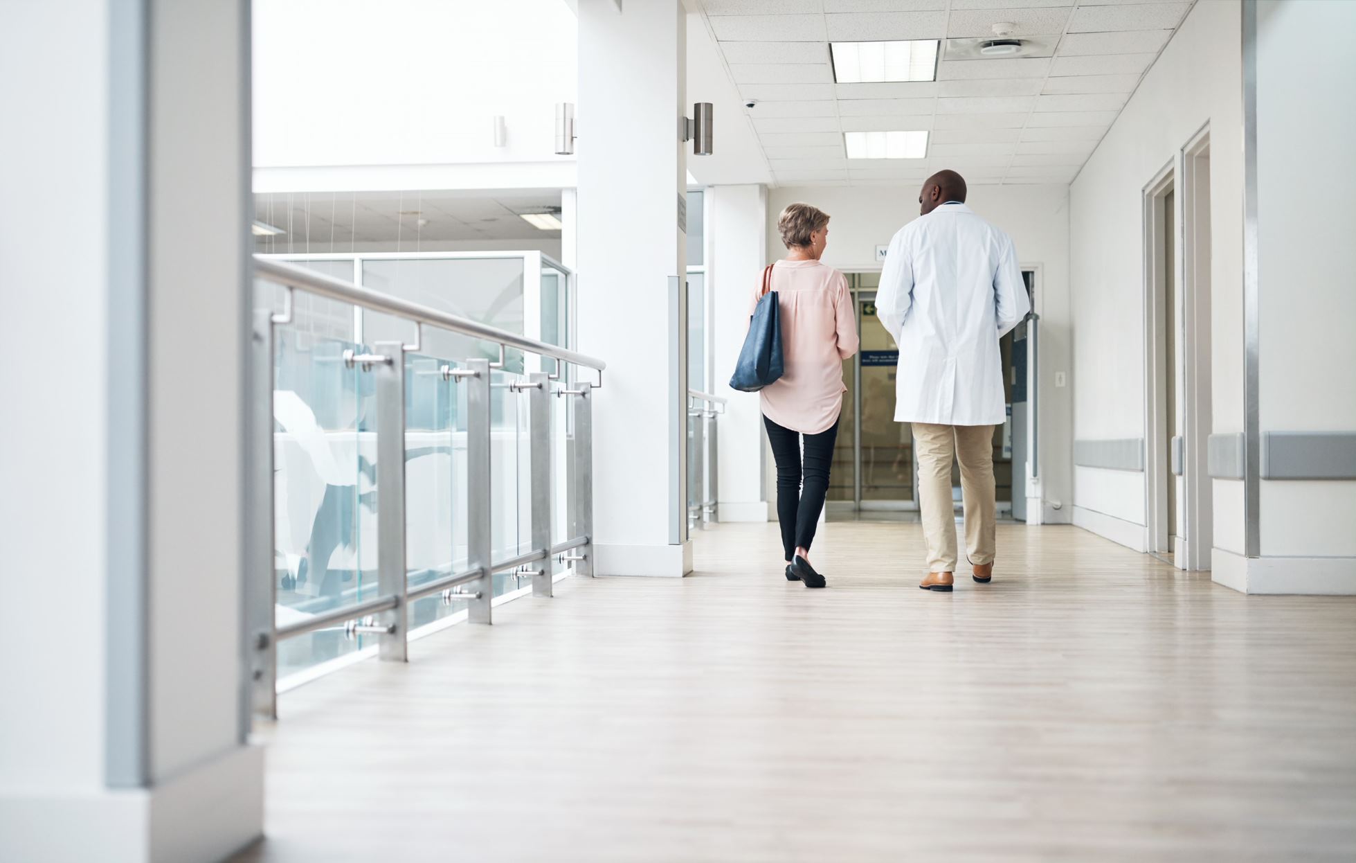 doctor and a patient walking at hospital hall