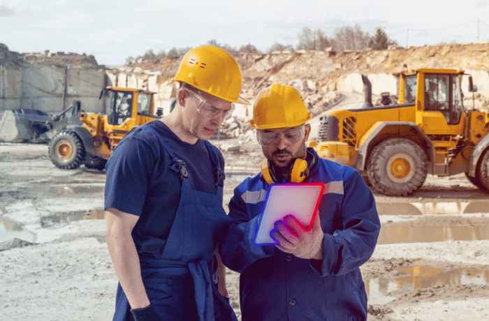 two construction workers looking at a paper