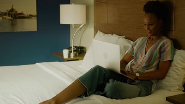 Woman on a laptop in a hotel room