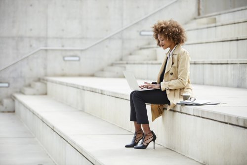 woman on the stairs with a laptop